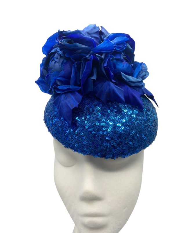 Stunning blue sequinned headpiece with handmade matching blue silk flower detail.